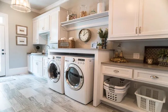 Laundry room with white cabinets, open shelves and a tile floor
